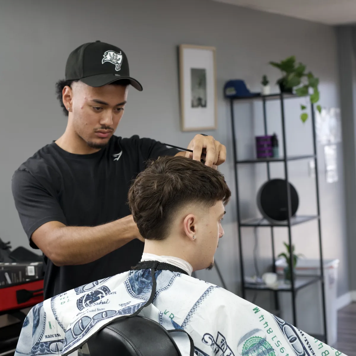 barber cutting a client hair at Faders Barber Studio in Largo FL